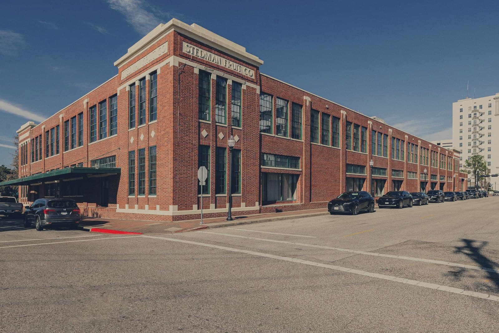 A brick commercial building on a New York street corner.