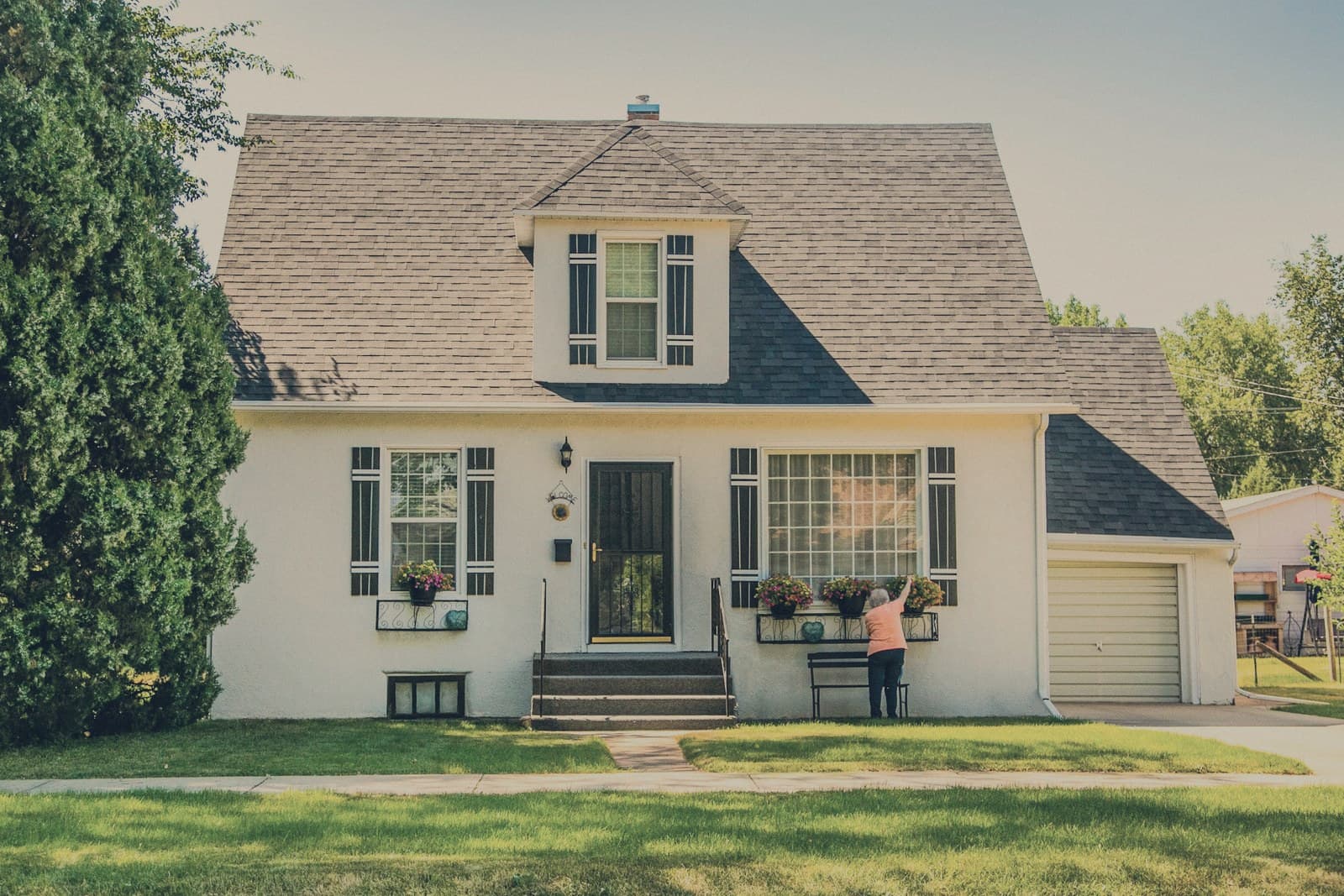 A quiet residential home on a tree-lined street.